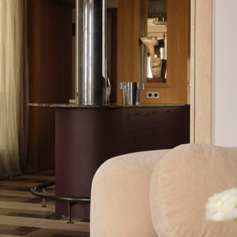 Wine-red kitchen forms centrepiece of apartment by Hauvette & Madani