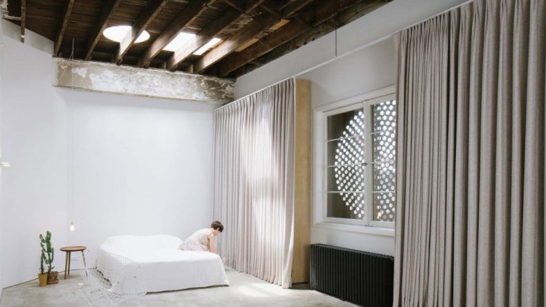 Eight home interiors where full-length curtains add a touch of drama